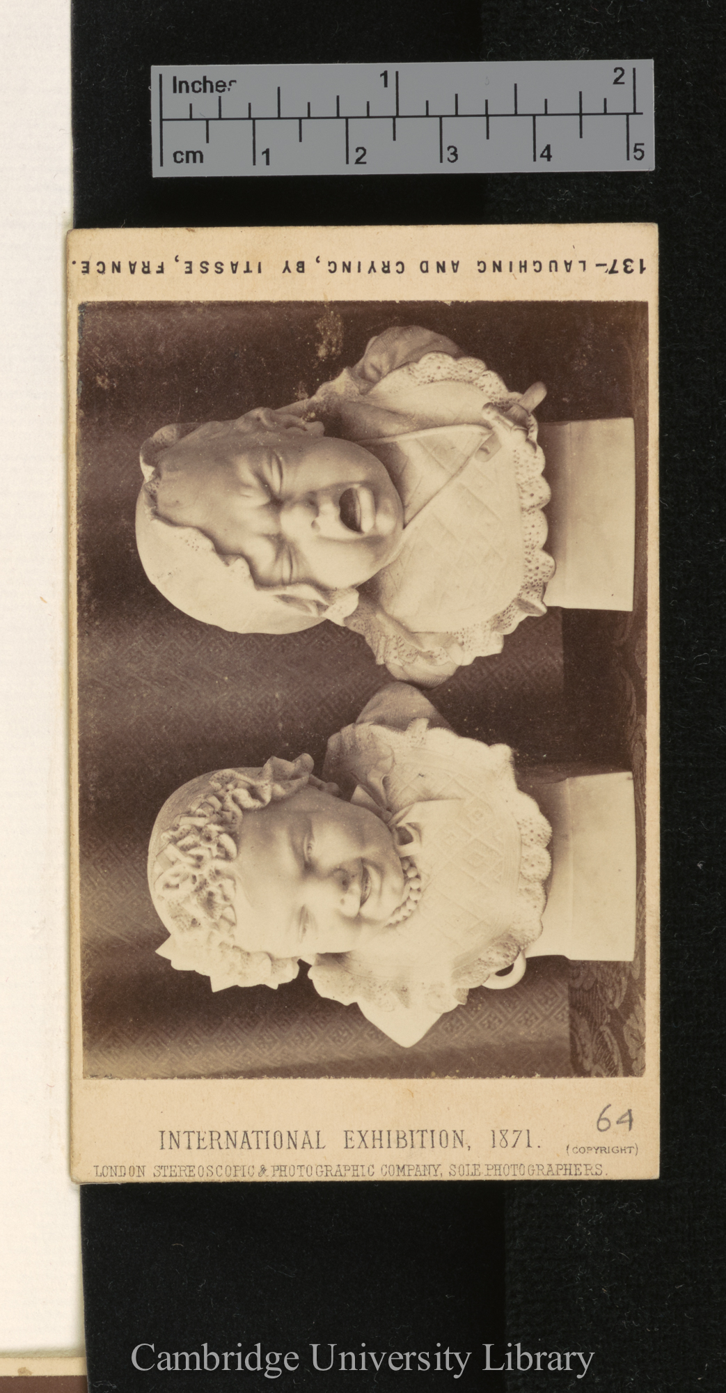 of sculptures of laughing and crying faces