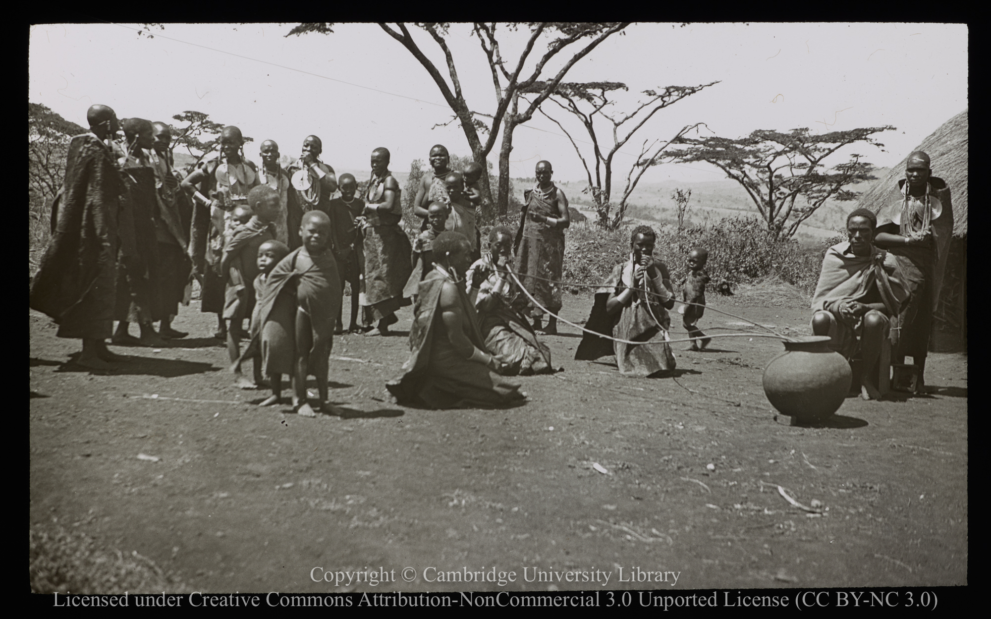 Kikuyu villagers drinking home-made beer, 1937