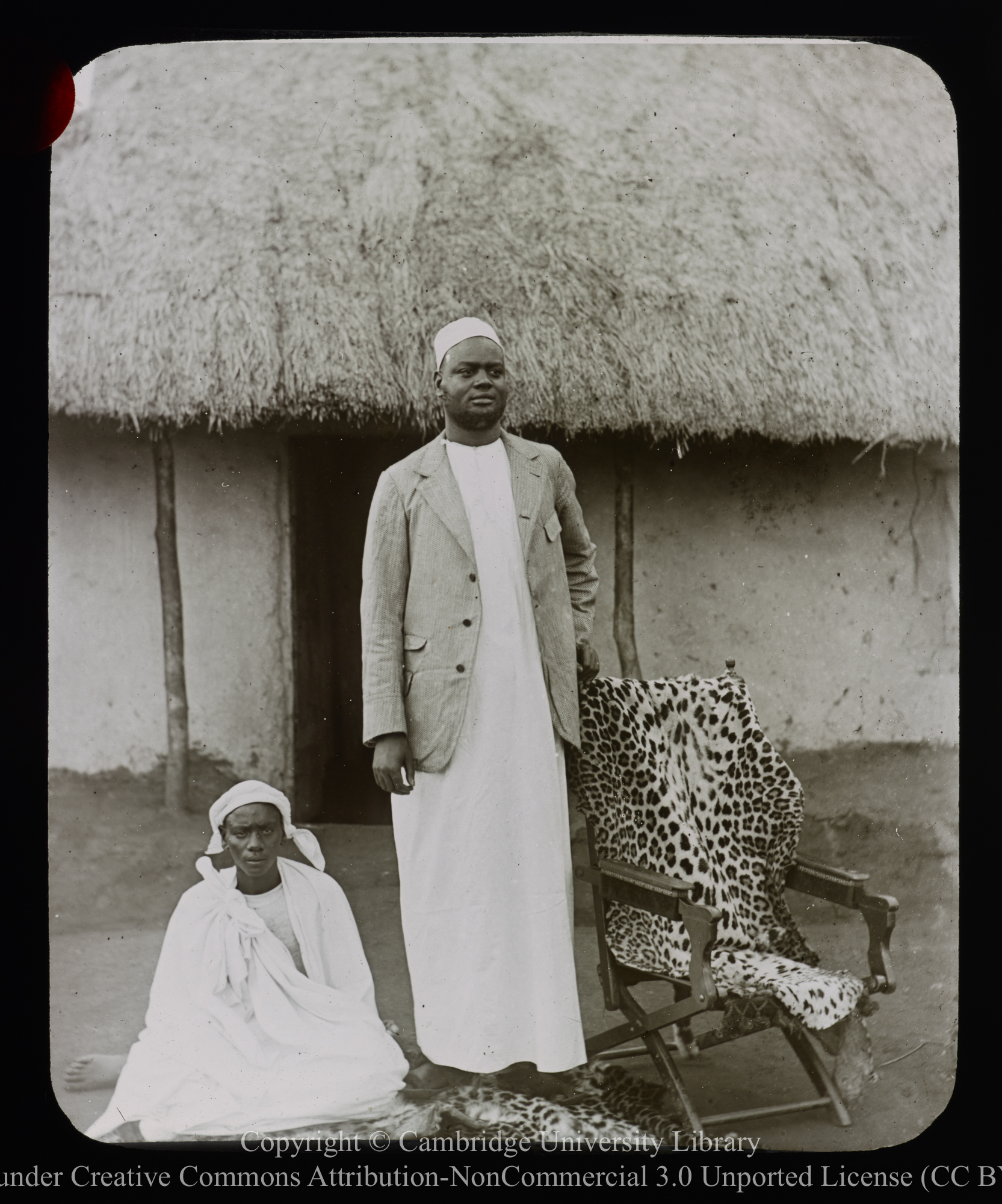 African couple outside house, 1892 - 1914