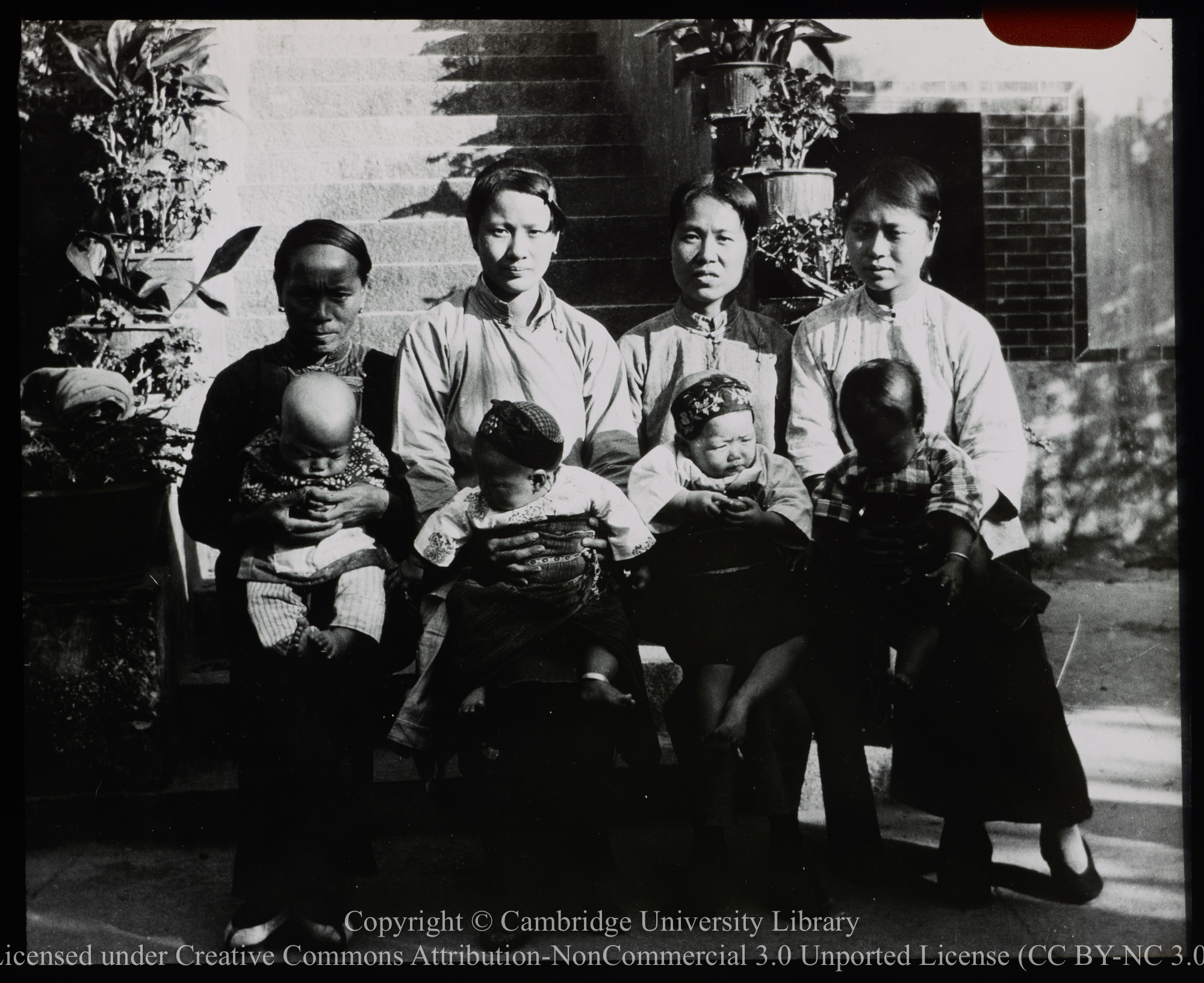 Four Chinese women with babies on their laps, 1900 - 1920
