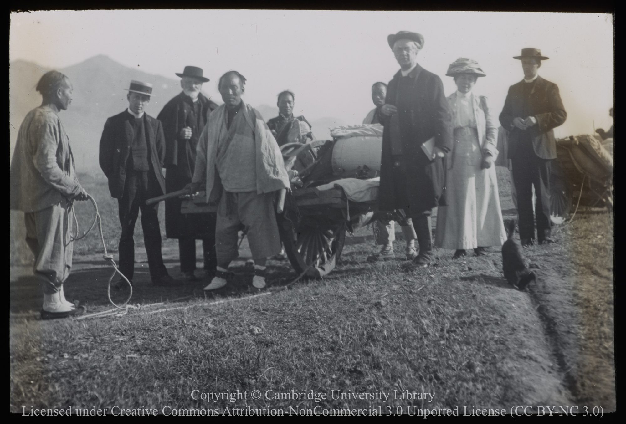Rev. J. Hunter and the Rev. and Mrs Matthews and others standing by wheelbarrow, 1900 - 1920