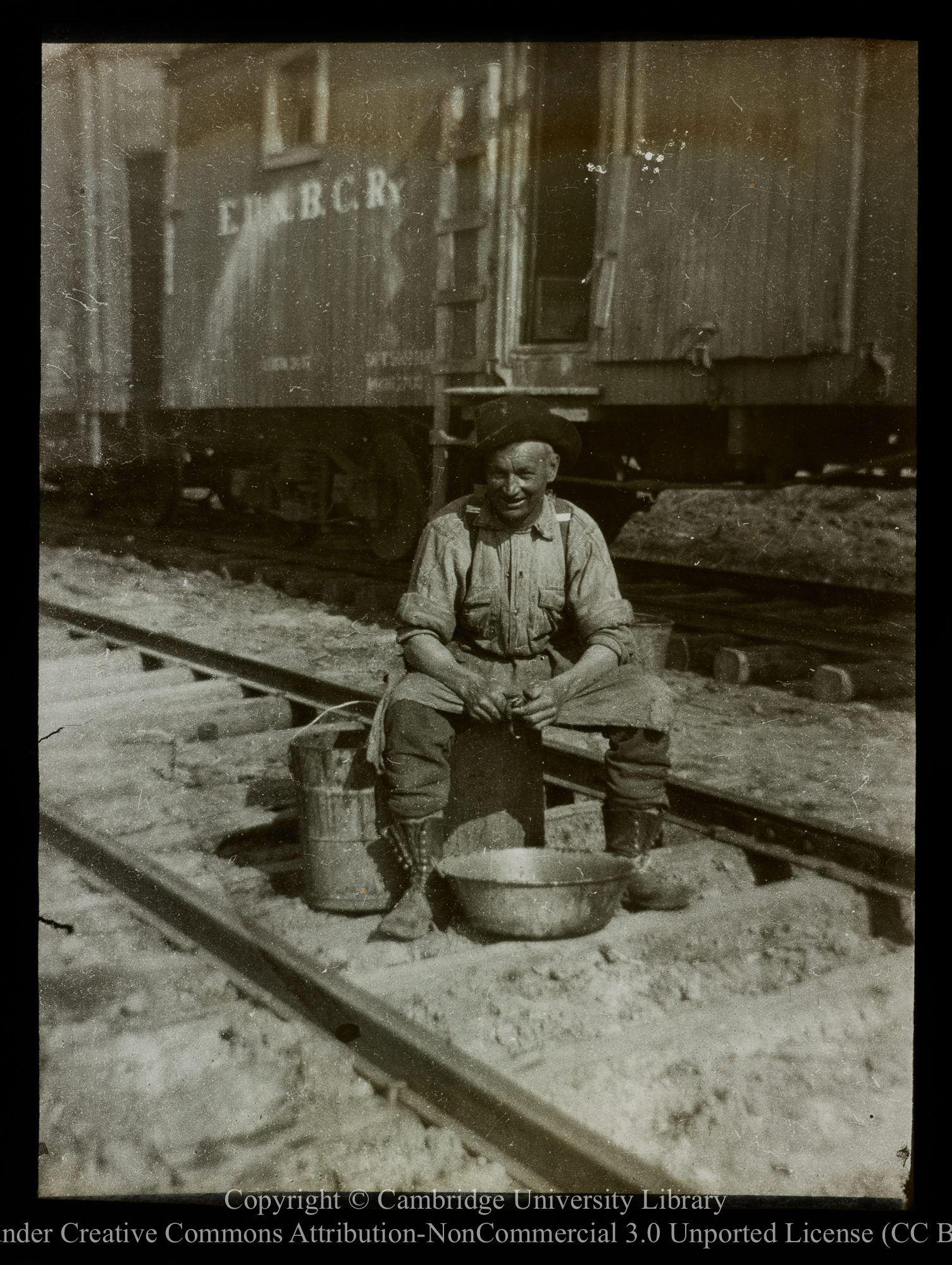 [Peeling potatoes by the Edmonton, Dunvegan and British Columbia railway], 1910 - 1930