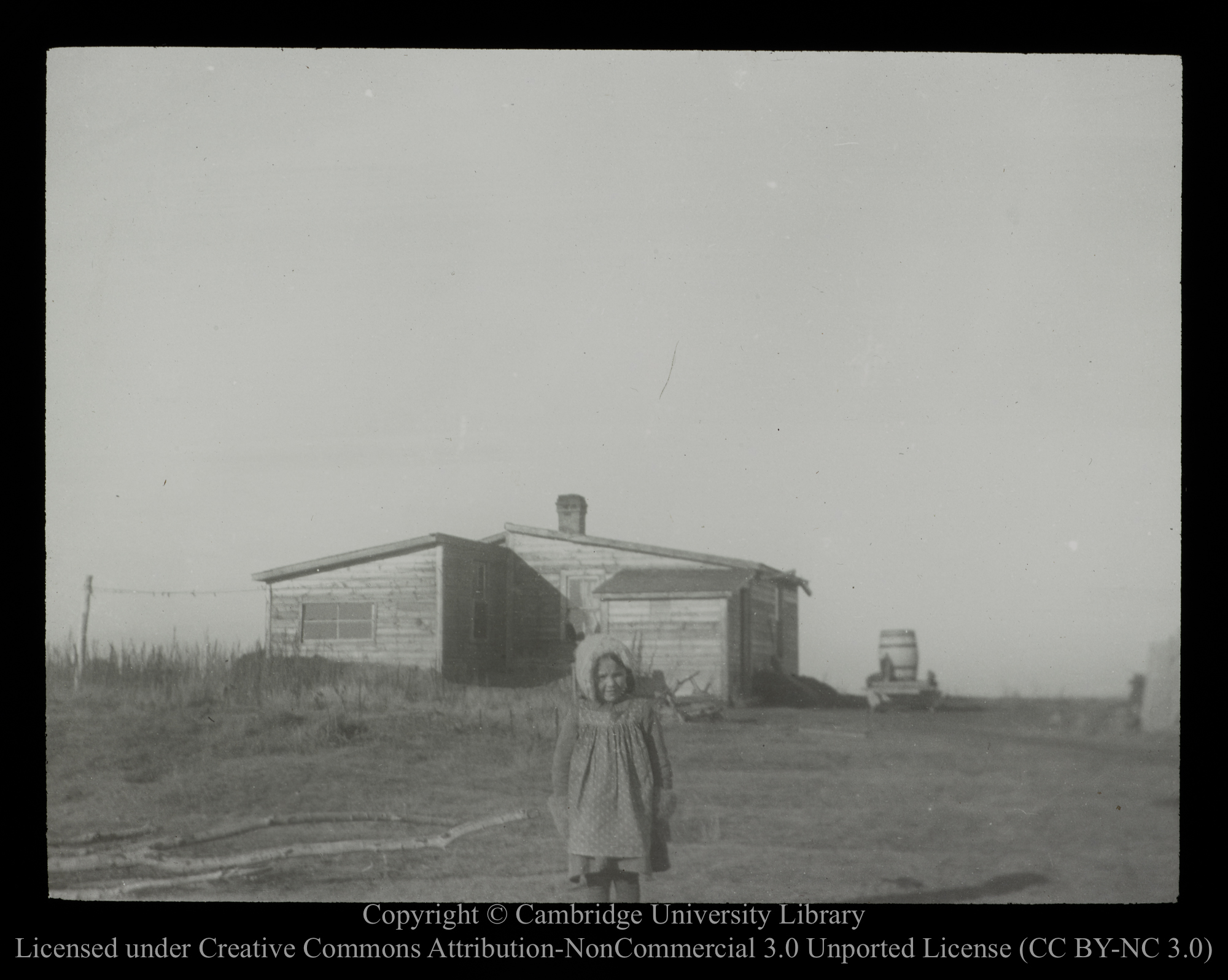 [Little girl, in front of homestead], 1910 - 1930